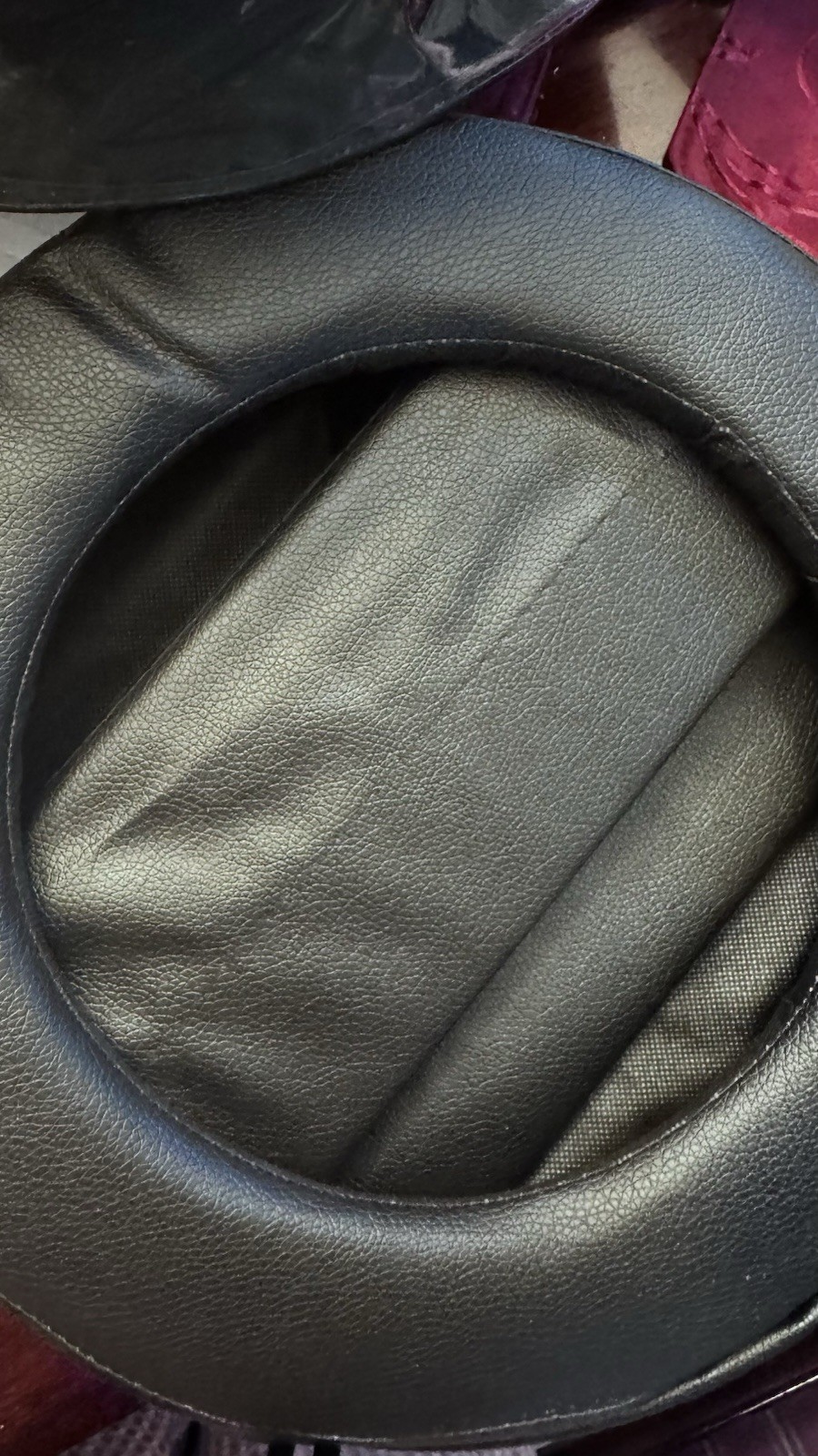 Portable Toilet: This black, circular zippered case is designed t To Hold It.