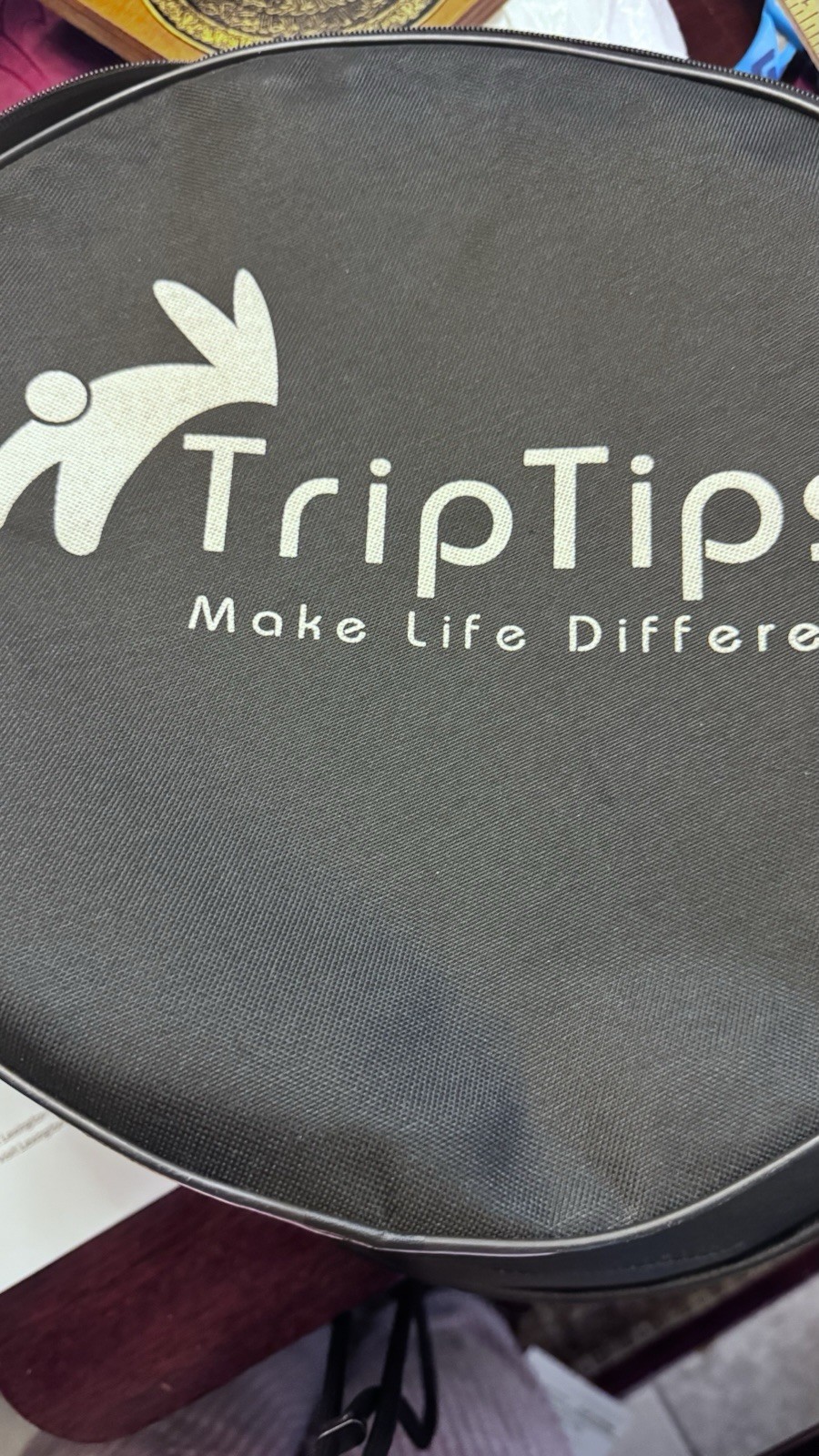 Portable Toilet: This black, circular zippered case is designed t To Hold It.