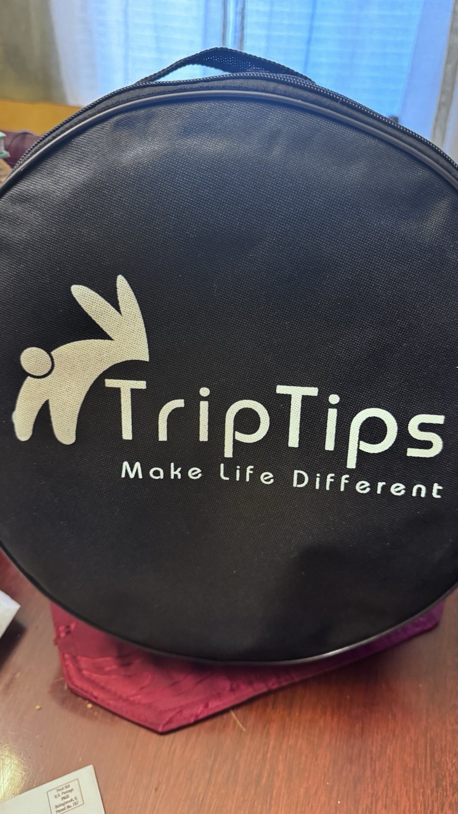 Portable Toilet: This black, circular zippered case is designed t To Hold It.