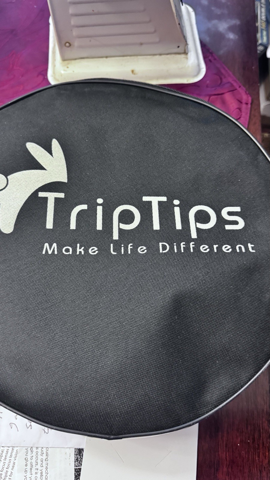 Portable Toilet: This black, circular zippered case is designed t To Hold It.
